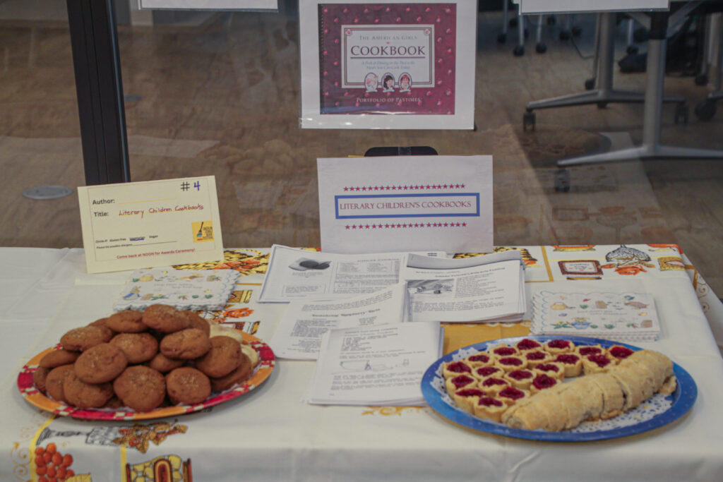Various cookbook printouts with plates of cookies and pastries.