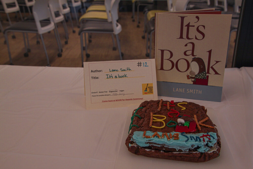 Replica of reference book cover with brownie base and frosting, candy, and pretzels for details.