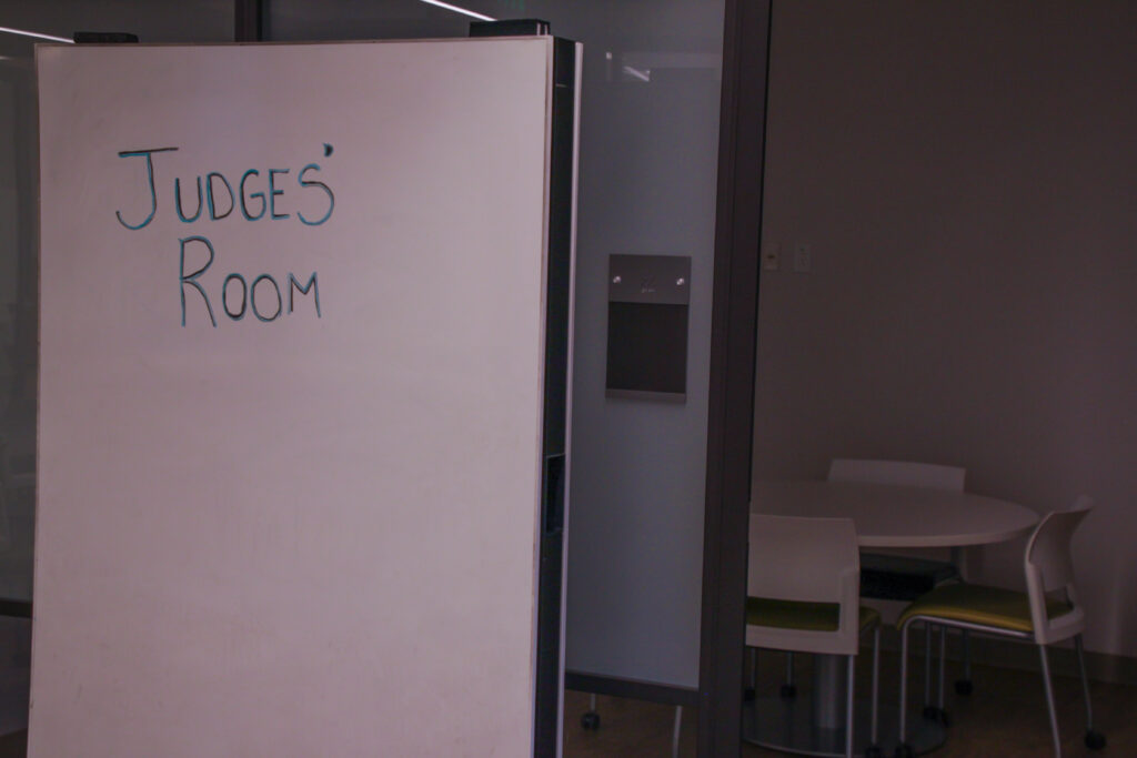 Whiteboard labelling room behind it as the Judges' Room.