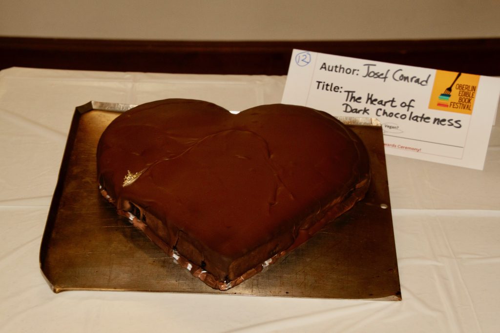 Photo of submission titled, "The Heart of Dark Chocolateness" featuring a heart-shaped chocolate cake with chocolate icing