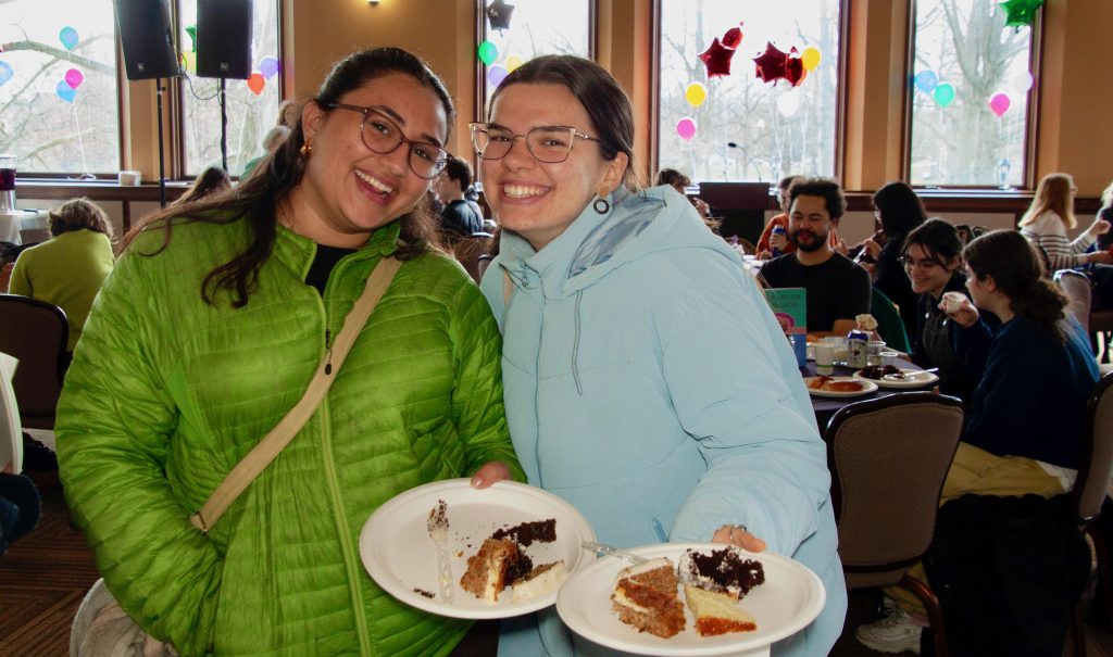 Two female attendees pose with their plates of samples